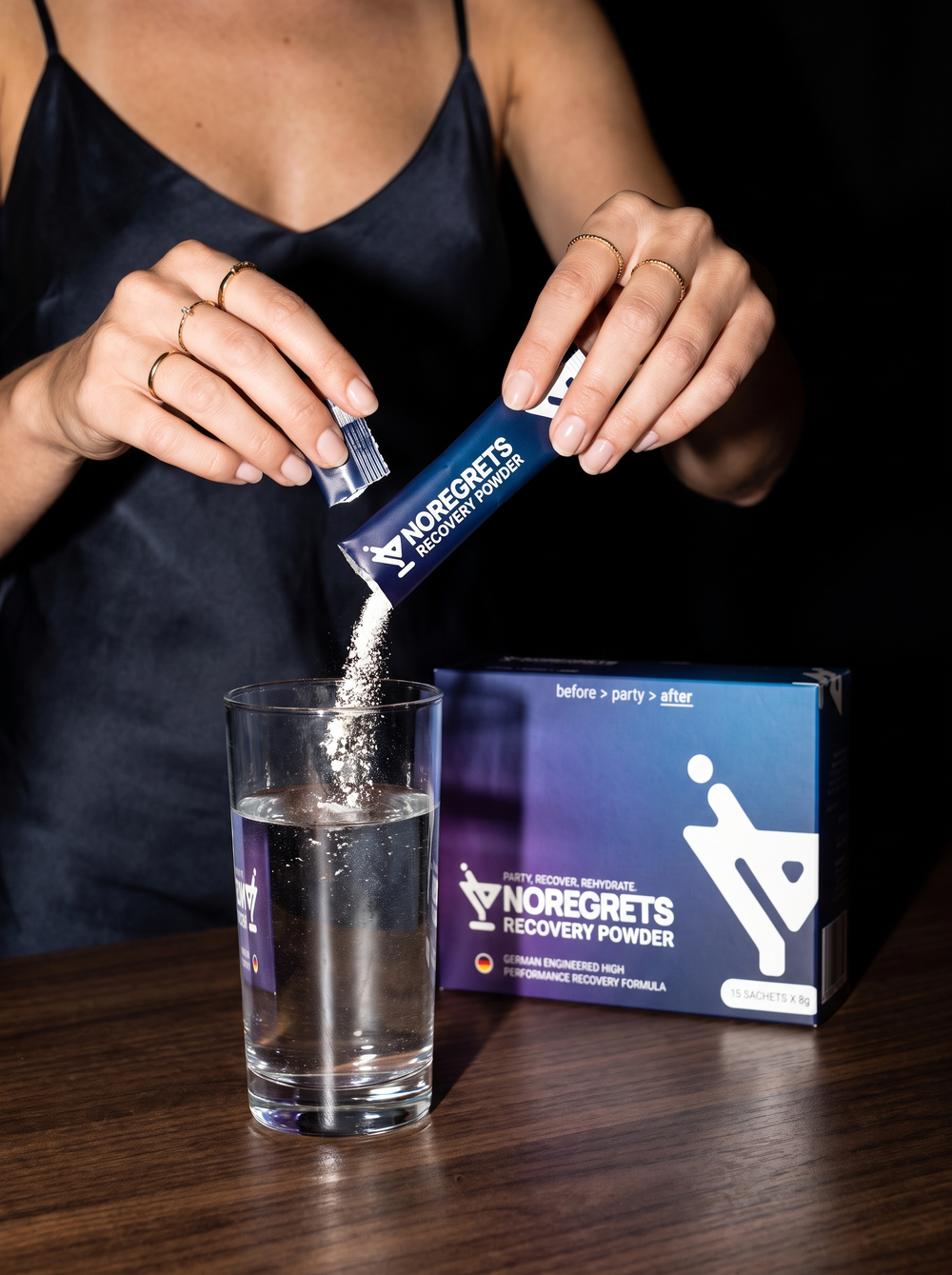 A sachet being stirred into a glass of water